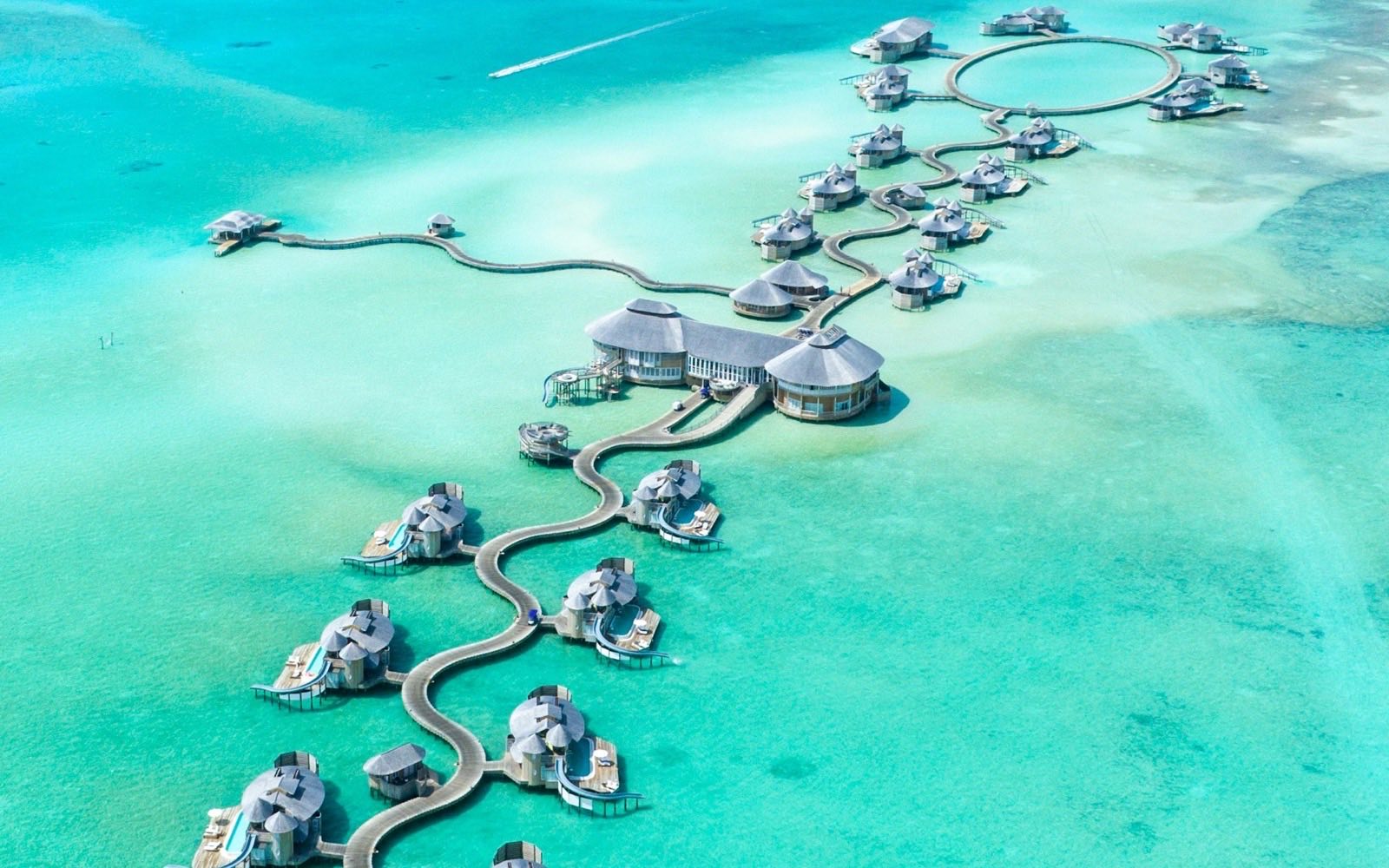 Overwater villas in a turquoise lagoon